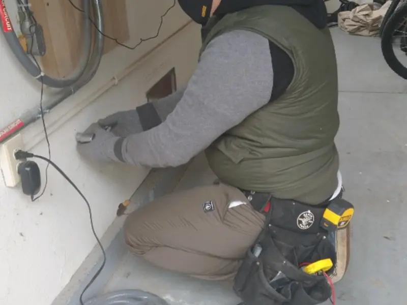 Electrician performing outlet wiring in a Shafter garage